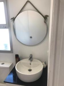a bathroom with a white sink and a mirror at Fascinating & Luxurious Golf,Mountain & Garden view apartment Porto Banus in Marbella +10 photos