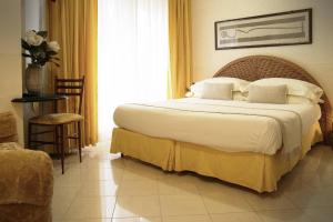 a bedroom with a large bed with white sheets and pillows at Locanda A Cà Du Gigante in Monterosso al Mare