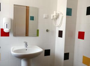 a bathroom with two sinks and a mirror at Sagres Sun Stay - Surf Camp & Hostel in Sagres