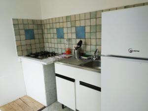 a small kitchen with a sink and a stove at B&B Littu in Cala Gonone