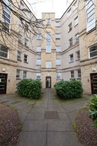 a large brick building with a door in a courtyard at amazing apartments - Annandale St near The Playhouse - Free Parking in Edinburgh
