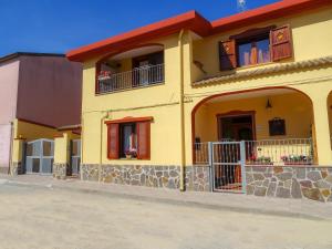 サッサリにあるI Due Ciuchini Sardiniaの赤屋根の黄色い家