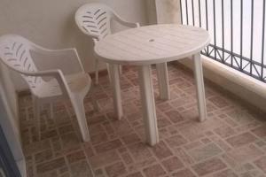 a white table and two chairs sitting next to a window at Casa Andalusí Carboneras in Carboneras