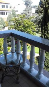 a bench on a balcony with a view of a park at Villa Verde Apartments and Rooms in Premantura