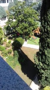 a view of a garden with a playground and a tree at Villa Verde Apartments and Rooms in Premantura