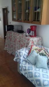 a bedroom with a table and a bed with pillows at Villa Verde Apartments and Rooms in Premantura
