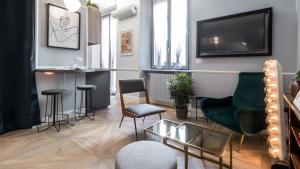 a living room with a couch and chairs and a tv at Italianway - Garigliano 4 Flat in Milan