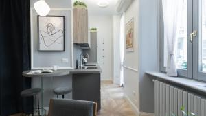 a kitchen with a counter and a sink in a room at Italianway - Garigliano 4 Flat in Milan