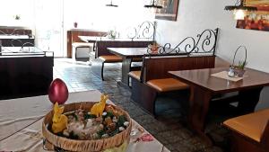 a restaurant with tables and chairs and a restaurant with a centerpiece of a room with at Hotel Elsenztal in Bammental