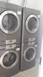 three washing machines sitting next to each other in a room at Seven Hostel & Rooms in Sant'Agnello