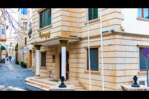 a building on a street in front of a building at Atropat Old City Hotel in Baku