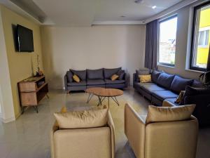 a living room with two couches and a table at Hotel Vesna in Međugorje