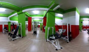 a gym with green and red walls and tread machines at B&B RELAX in Messina