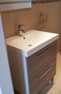 a bathroom with a white sink and a mirror at Villa A funtanella in Patrimonio