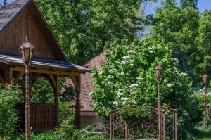 a garden with a gazebo and a tree with white flowers at Charivna Taistra in Brovary