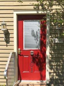 a red door on the side of a house at The Guest Room in Abbeville