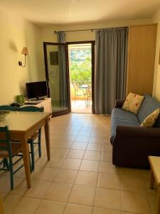 a living room with a couch and a table at Hapimag Resort Cefalù in Cefalù