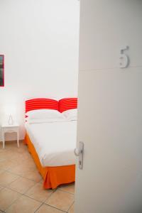 a bedroom with a bed with an orange and white at Casa Sorrentina in Sorrento