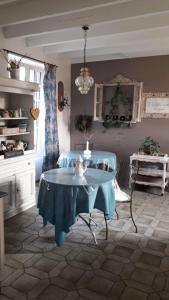 a dining room with a table and a chair at La Porte Ouverte in Saint-Denoual