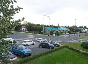 a group of cars parked in a parking lot at Sogavegur 103 in Reykjavík