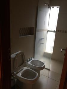 a bathroom with a toilet and a sink at Madre Natura in Asuncion