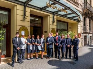 men and women posing for a picture in front of a building at Hotel Roger de Llúria in Barcelona