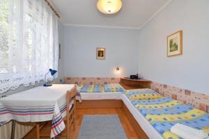a room with two beds and a table at Ubytovanie Dagmar in Svätý Jur
