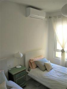 a bedroom with a bed and a window at Casinomar Frente al Mar in Benalmádena