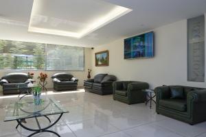 a living room with couches and a glass table at Zoukotel Hotel in Jounieh