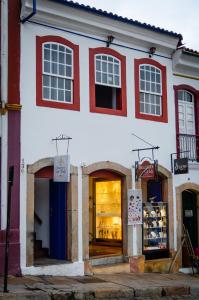a red and white building with a store at Caminhos De Ouro Preto in Ouro Preto