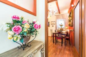 a vase of flowers on a fireplace in a living room at Emperor's Suites in Split