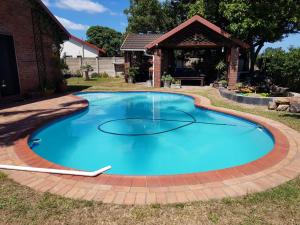 a large blue pool with a brick pathway around it at Cassiandra Place unit 2 in Richards Bay