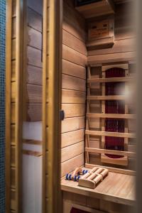 a walk in closet with wooden walls and wooden shelves at Emperor's Suites in Split