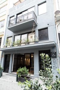 un edificio con un balcón con plantas. en Concierge Monastiraki en Athens