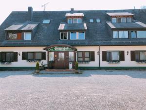 a large white building with a gate in front of it at Gästehaus Ehebachhof Hotel Garni in Müllheim