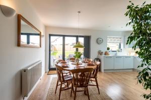a kitchen and dining room with a table and chairs at Beach Retreat in Whitstable