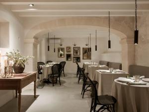 a restaurant with tables and chairs in a room at Finca Serena Mallorca, Small Luxury Hotels in Montuiri