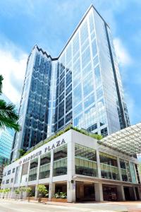 a large glass building in front of a building at Harbour Plaza North Point in Hong Kong
