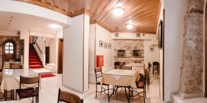 a dining room with a table and chairs and a staircase at Kentrikon in Ioannina