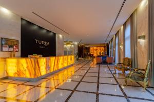 a lobby of a ted baker store with a large sign on the wall at TURIM Boulevard Hotel in Lisbon +17 photos