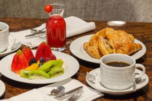 a table with plates of food and a cup of coffee at TURIM Boulevard Hotel in Lisbon