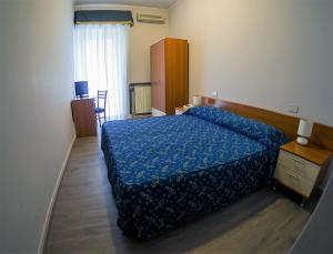 Letto o letti in una camera di Albergo Dei Leoni