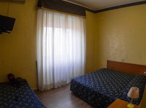 Letto o letti in una camera di Albergo Dei Leoni