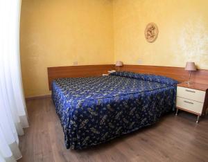 Letto o letti in una camera di Albergo Dei Leoni