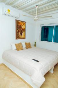 Säng eller sängar i ett rum på Hotel Palmera Beach Cartagena