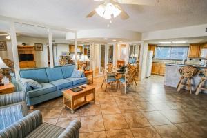 a living room with a blue couch and a table at Coral Reef Resort in St Pete Beach