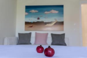 two apples sitting on top of a bed at KaitiapARTments in Toroni