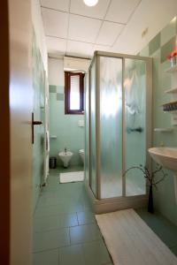 a bathroom with a shower and a toilet and a sink at Casa Al Carmine in Padova