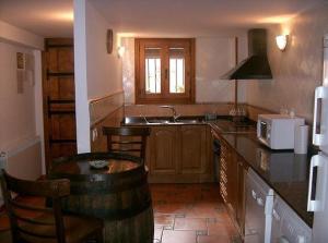 a kitchen with a sink and a counter top at Casa Rural Benito in Las Cuevas de Cañart +9 photos
