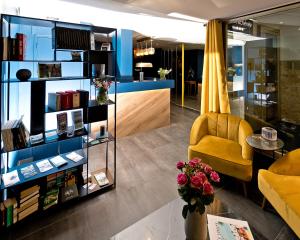 a store with a yellow chair and a table at ATH hôtel Athénée in Cannes